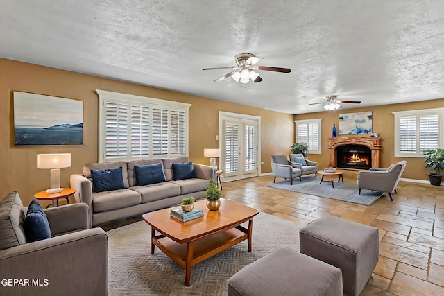 796 Fescue Dr, Canutillo, TX 79835 - living room with a ceiling fan, a warm lit fireplace, and a textured ceiling