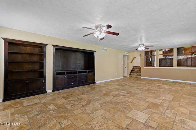 796 Fescue Dr, Canutillo, TX 79835 - unfurnished living room with ceiling fan, a textured ceiling, stairway, and stone tile floors