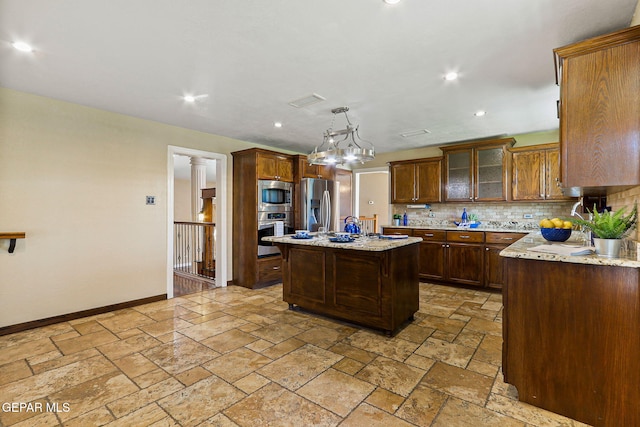 796 Fescue Dr, Canutillo, TX 79835 - kitchen featuring tasteful backsplash, stainless steel appliances, stone tile floors, a kitchen island, and recessed lighting