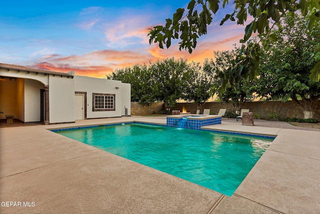 796 Fescue Dr, Canutillo, TX 79835 - pool at dusk featuring an in-ground hot tub, a patio area, and a fenced backyard