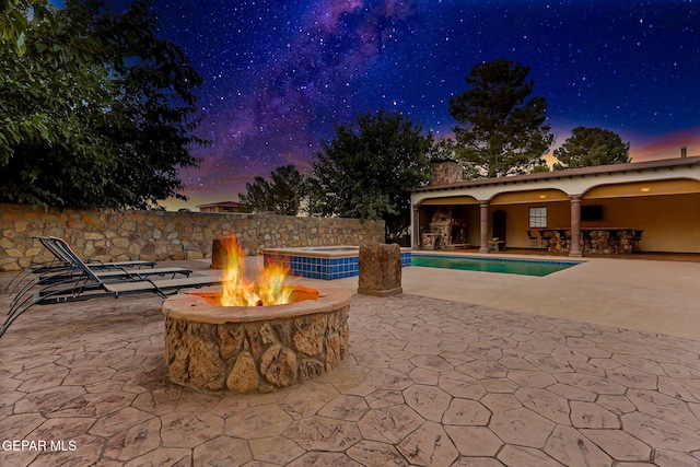 796 Fescue Dr, Canutillo, TX 79835 - patio terrace at dusk featuring a fire pit, a patio, and a pool with connected hot tub