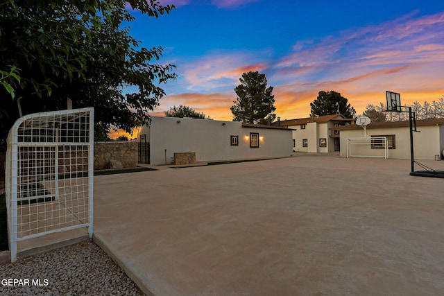 796 Fescue Dr, Canutillo, TX 79835 - back of property at dusk featuring stucco siding and a gate