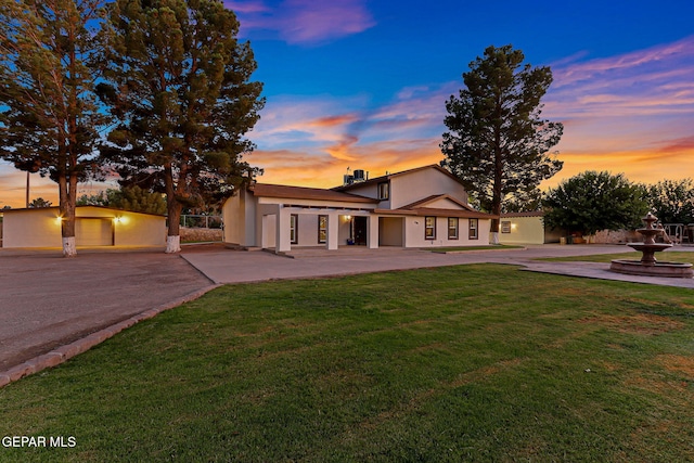 796 Fescue Dr, Canutillo, TX 79835 - mid-century inspired home featuring curved driveway, a front lawn, stucco siding, and a patio area