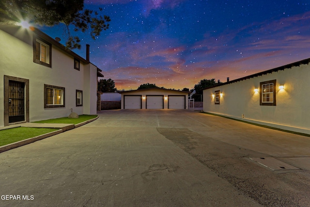 796 Fescue Dr, Canutillo, TX 79835 - property exterior at dusk featuring an outbuilding, stucco siding, and a detached garage