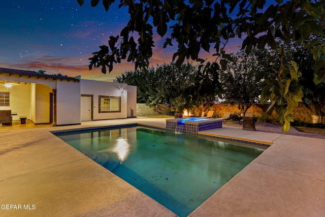 796 Fescue Dr, Canutillo, TX 79835 - pool at dusk featuring a patio area and a pool with connected hot tub
