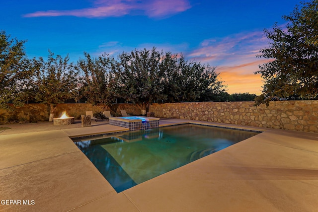 796 Fescue Dr, Canutillo, TX 79835 - pool at dusk featuring a patio area, a pool with connected hot tub, and a fenced backyard