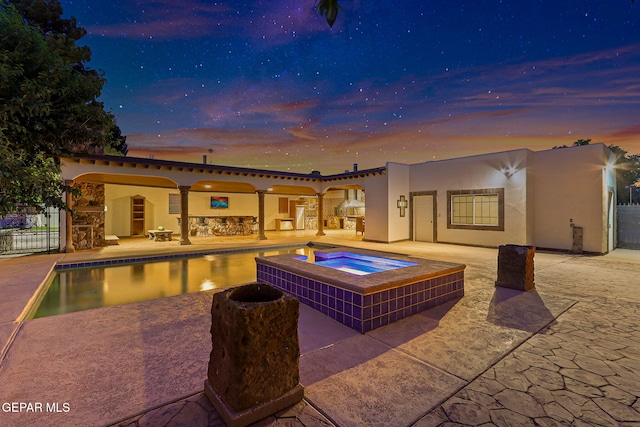 796 Fescue Dr, Canutillo, TX 79835 - pool at dusk with an in-ground hot tub, a patio area, and an outdoor pool