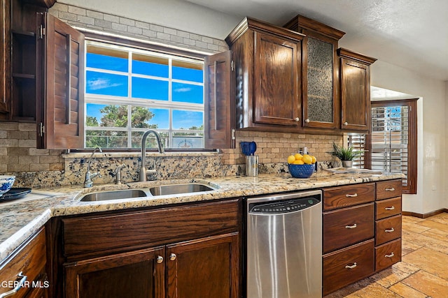 796 Fescue Dr, Canutillo, TX 79835 - kitchen featuring stainless steel dishwasher, stone tile floors, tasteful backsplash, light stone counters, and dark brown cabinets