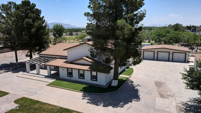 796 Fescue Dr, Canutillo, TX 79835 - view of front of property featuring a mountain view, driveway, a garage, stucco siding, and roof with shingles