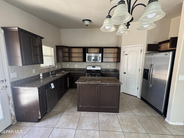 14325 Woods Point Ave, El Paso, TX 79938 - kitchen featuring stainless steel appliances, open shelves, dark stone counters, and tasteful backsplash