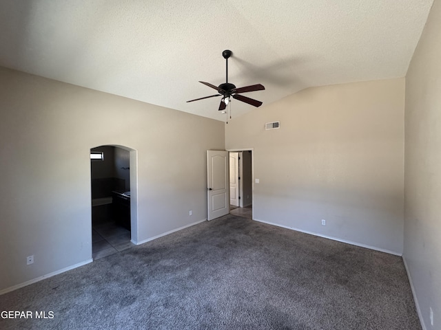 14325 Woods Point Ave, El Paso, TX 79938 - unfurnished bedroom with arched walkways, carpet flooring, vaulted ceiling, a textured ceiling, and a ceiling fan