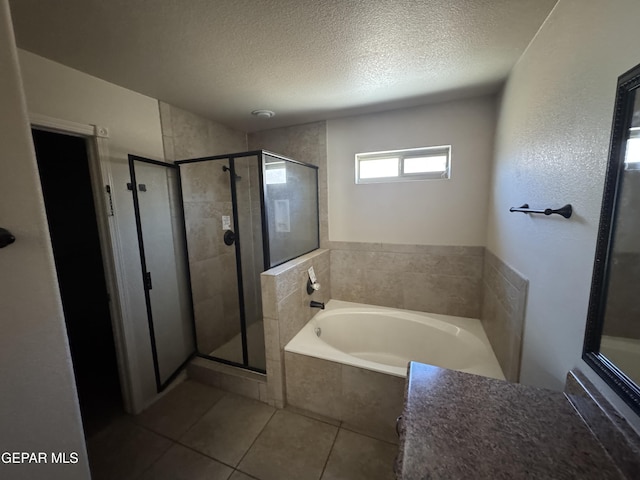 14325 Woods Point Ave, El Paso, TX 79938 - bathroom with a bath, a textured ceiling, tile patterned floors, and a shower stall