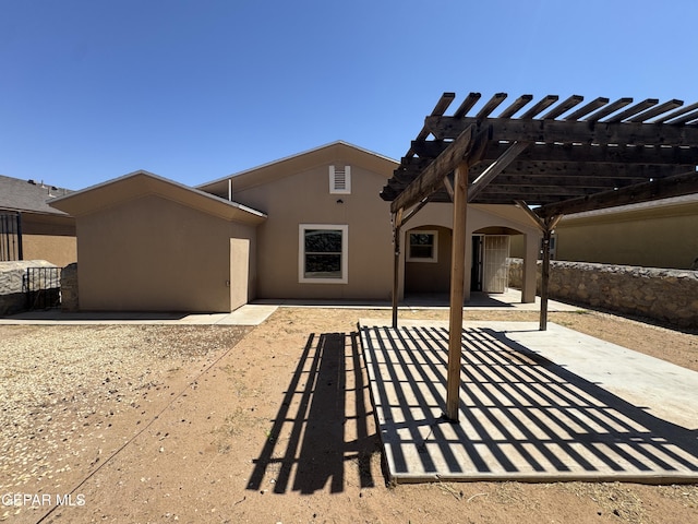 14325 Woods Point Ave, El Paso, TX 79938 - rear view of property featuring stucco siding, a patio area, and a pergola