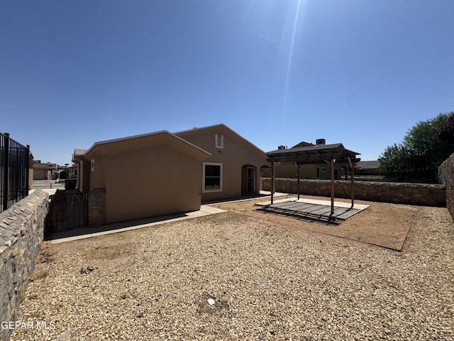 14325 Woods Point Ave, El Paso, TX 79938 - back of property featuring a pergola, a patio, stucco siding, and a gate