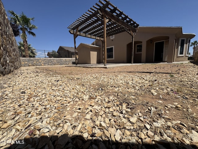 14325 Woods Point Ave, El Paso, TX 79938 - rear view of house featuring a pergola and stucco siding