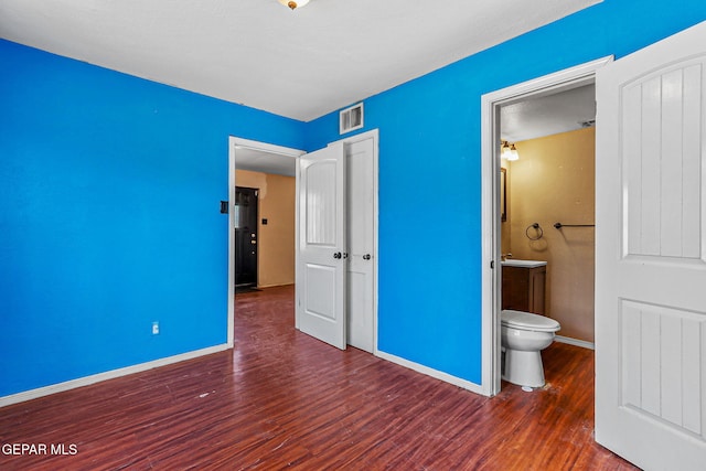 541 Val Verde St, El Paso, TX 79905 - unfurnished bedroom with wood finished floors and connected bathroom