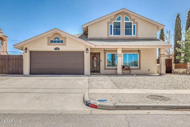 7366 Luz De Dia Ct, El Paso, TX 79912 - view of front of property with stucco siding, a garage, a shingled roof, and driveway