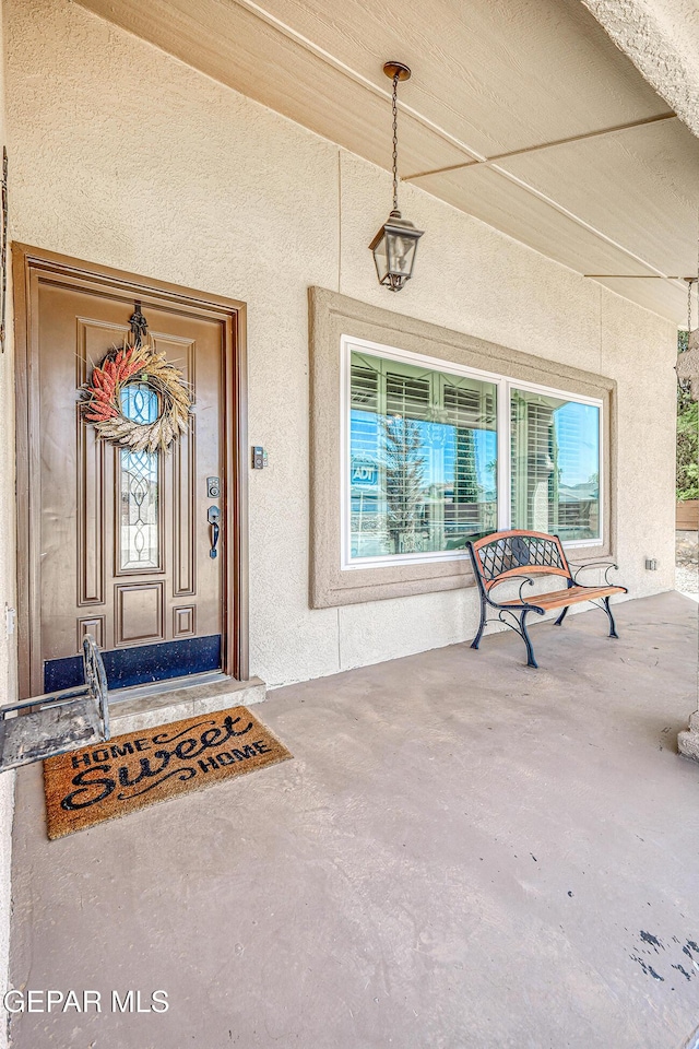 7366 Luz De Dia Ct, El Paso, TX 79912 - view of exterior entry featuring stucco siding and a porch