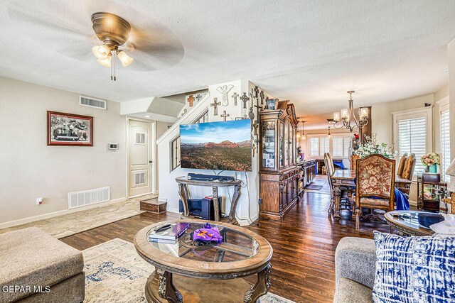 7366 Luz De Dia Ct, El Paso, TX 79912 - living area featuring a chandelier, wood finished floors, ceiling fan, a textured ceiling, and stairs