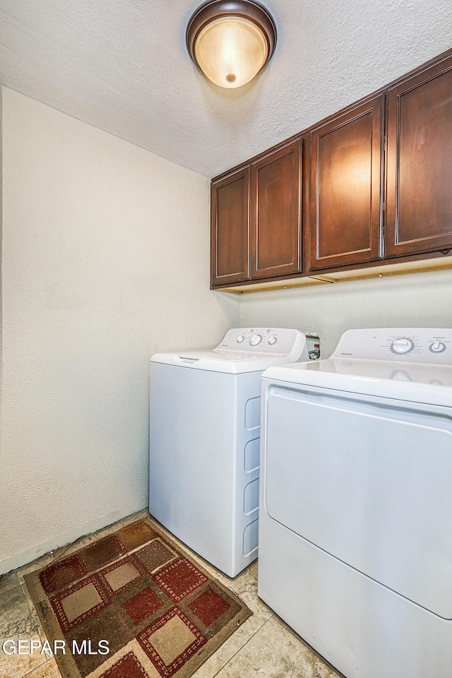 7366 Luz De Dia Ct, El Paso, TX 79912 - laundry area with cabinet space, washer and dryer, and a textured ceiling