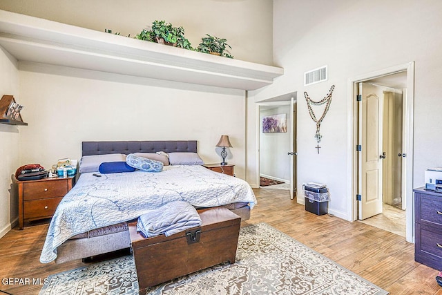 7366 Luz De Dia Ct, El Paso, TX 79912 - bedroom featuring wood finished floors and a towering ceiling