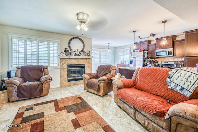 7366 Luz De Dia Ct, El Paso, TX 79912 - living room featuring healthy amount of natural light, ceiling fan, and a high end fireplace