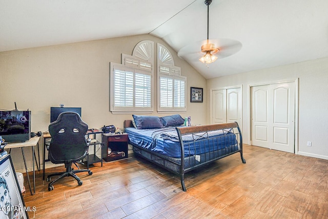 7366 Luz De Dia Ct, El Paso, TX 79912 - bedroom with lofted ceiling, light wood finished floors, two closets, and a ceiling fan