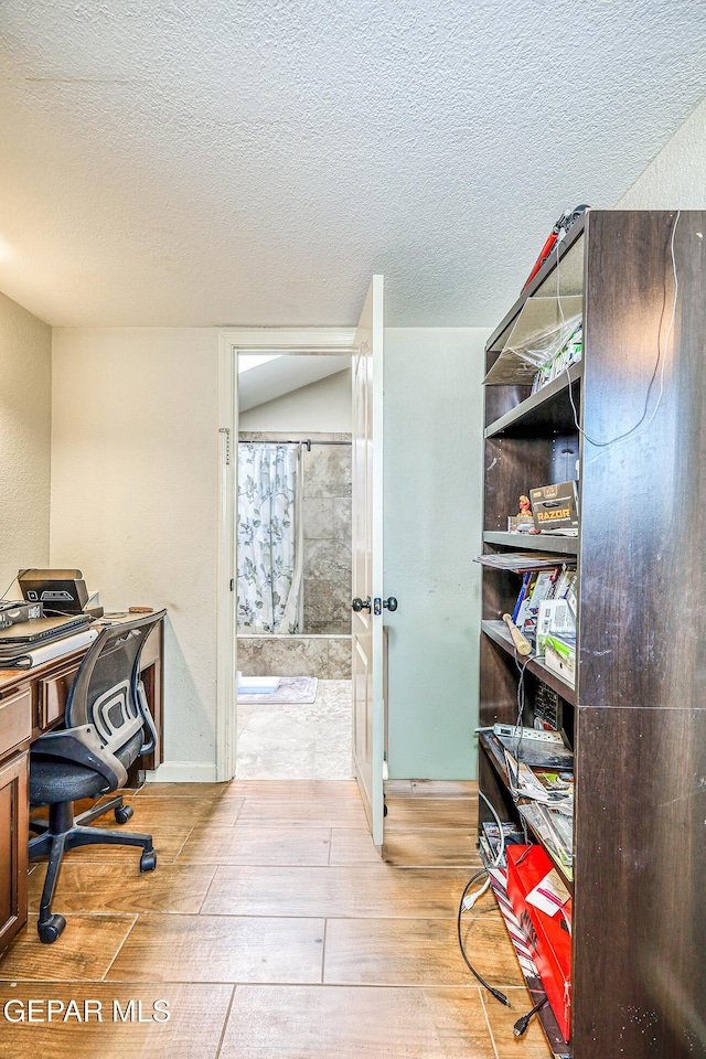 7366 Luz De Dia Ct, El Paso, TX 79912 - office area featuring light wood-type flooring and a textured ceiling