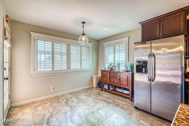 7366 Luz De Dia Ct, El Paso, TX 79912 - kitchen with stainless steel refrigerator with ice dispenser, dark brown cabinets, and decorative light fixtures