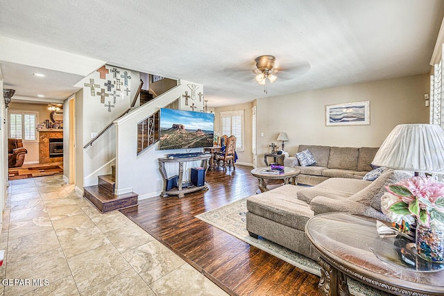 7366 Luz De Dia Ct, El Paso, TX 79912 - living room featuring stairs, ceiling fan, and a fireplace