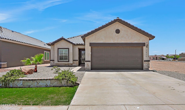 13860 Paseo Sereno Dr, El Paso, TX 79928 - view of front of home featuring a garage, stone siding, stucco siding, concrete driveway, and a tile roof