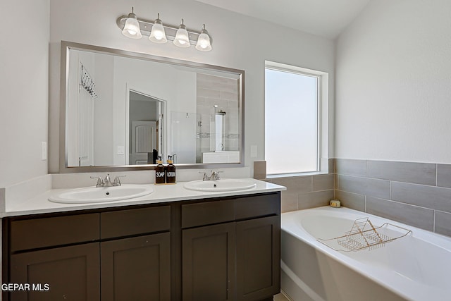 13860 Paseo Sereno Dr, El Paso, TX 79928 - bathroom featuring double vanity, a bath, and a stall shower