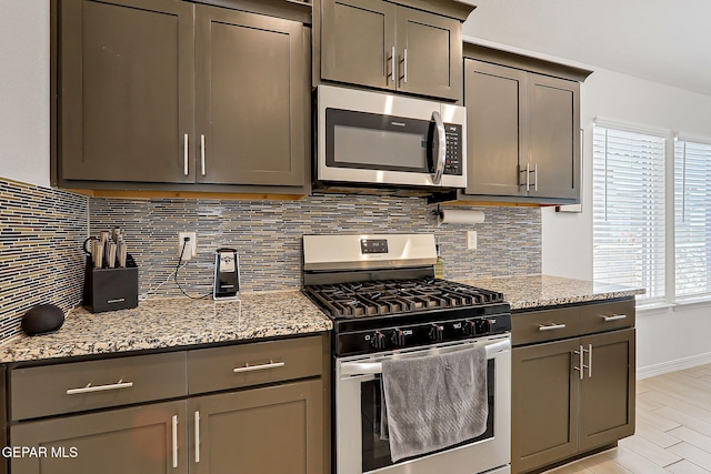 13860 Paseo Sereno Dr, El Paso, TX 79928 - kitchen with stainless steel appliances, backsplash, light stone counters, and gray cabinets