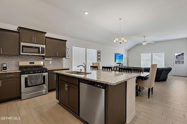 13860 Paseo Sereno Dr, El Paso, TX 79928 - kitchen with stainless steel appliances, backsplash, a chandelier, dark brown cabinets, and lofted ceiling