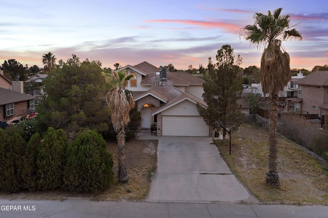 5713 Saplinas Rd, El Paso, TX 79932 - view of front of property featuring a garage, concrete driveway, and a residential view