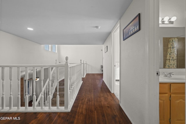 5713 Saplinas Rd, El Paso, TX 79932 - hallway with wood finished floors and an upstairs landing
