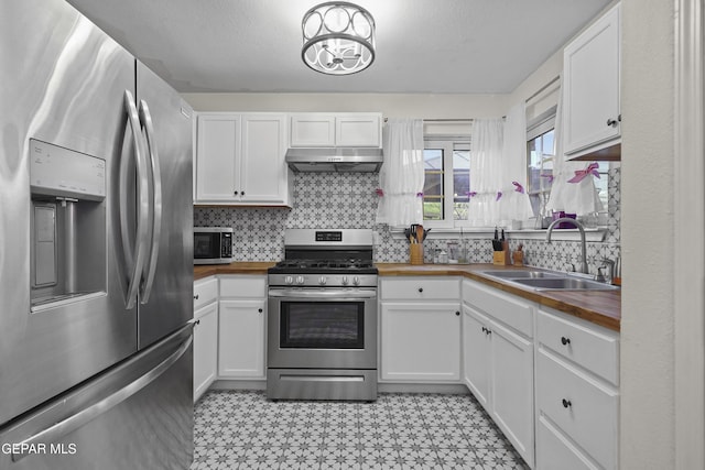 5713 Saplinas Rd, El Paso, TX 79932 - kitchen featuring stainless steel appliances, wooden counters, light flooring, and under cabinet range hood