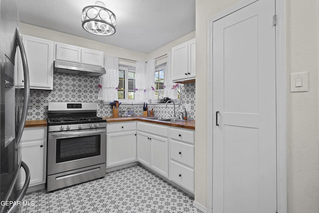 5713 Saplinas Rd, El Paso, TX 79932 - kitchen featuring stainless steel appliances, under cabinet range hood, butcher block countertops, and light flooring
