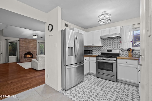 5713 Saplinas Rd, El Paso, TX 79932 - kitchen with appliances with stainless steel finishes, under cabinet range hood, white cabinetry, and ceiling fan
