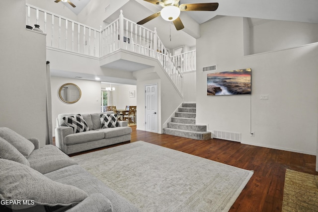 5713 Saplinas Rd, El Paso, TX 79932 - living room with ceiling fan, stairway, hardwood / wood-style floors, a high ceiling, and a chandelier