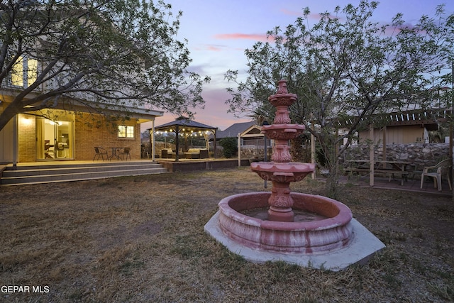 5713 Saplinas Rd, El Paso, TX 79932 - yard at dusk with a gazebo