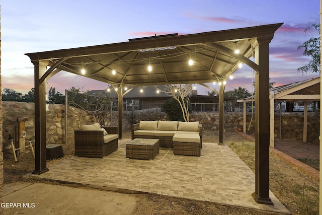 5713 Saplinas Rd, El Paso, TX 79932 - patio terrace at dusk featuring a gazebo, an outdoor living space, and a patio area
