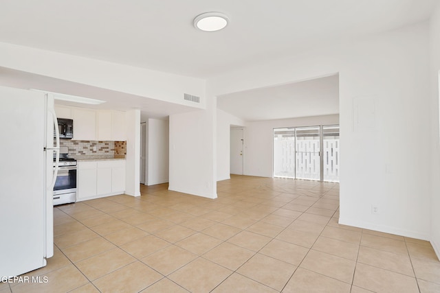 241 Mardi Gras Dr, El Paso, TX 79912 - unfurnished living room with vaulted ceiling and light tile patterned floors
