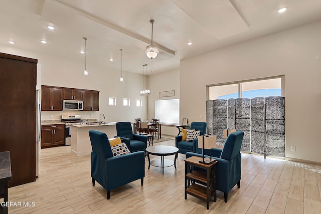 7825 Enchanted View Dr, El Paso, TX 79911 - living room with a high ceiling, light wood-style flooring, and recessed lighting