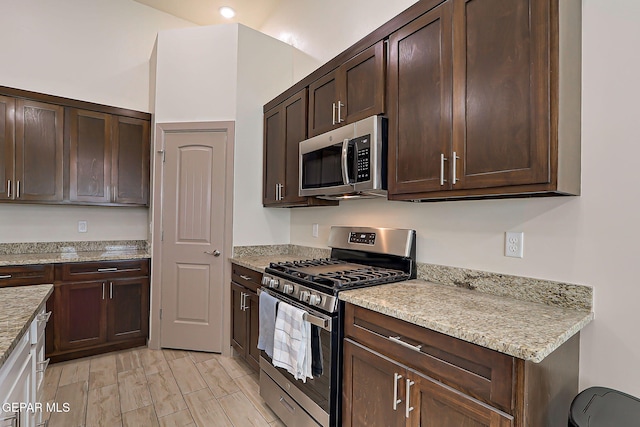 7825 Enchanted View Dr, El Paso, TX 79911 - kitchen featuring stainless steel appliances, dark brown cabinets, and light stone counters