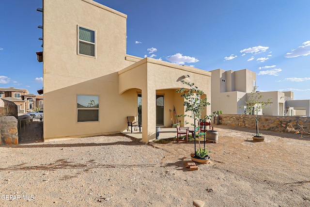 7825 Enchanted View Dr, El Paso, TX 79911 - back of property with stucco siding and a patio
