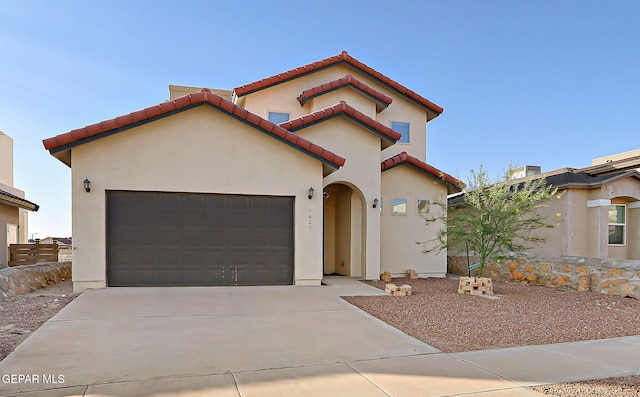 7825 Enchanted View Dr, El Paso, TX 79911 - mediterranean / spanish-style house featuring stucco siding, driveway, an attached garage, and a tile roof