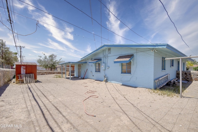 1268 Stanley St, El Paso, TX 79907 - back of property with brick siding and a storage shed
