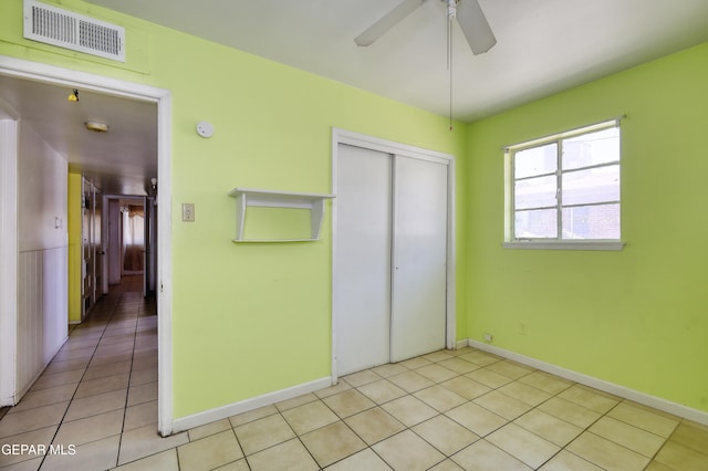 1268 Stanley St, El Paso, TX 79907 - unfurnished bedroom with a closet, light tile patterned floors, and a ceiling fan
