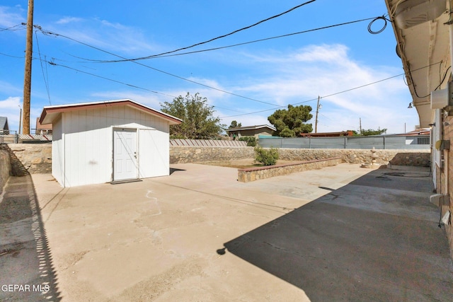 8763 Cathedral Cir, El Paso, TX 79907 - fenced backyard featuring a patio area and a storage unit